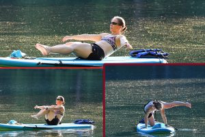 Ripped athletic woman doing Paddle Fit moves on her SUP board