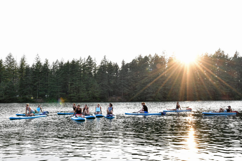 Women relaxing on their stand up paddle boards lacamas lake after a hard workout!