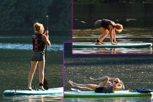 Redhaired Women working hard at SUP Paddle Boarding Fitness Class