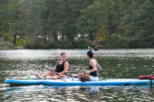 Girls smiling on their stand up paddle boards lacamas lake washington