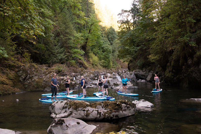 Group of women on stand up paddle boards on Lake Merwin and the Lewis River paddling